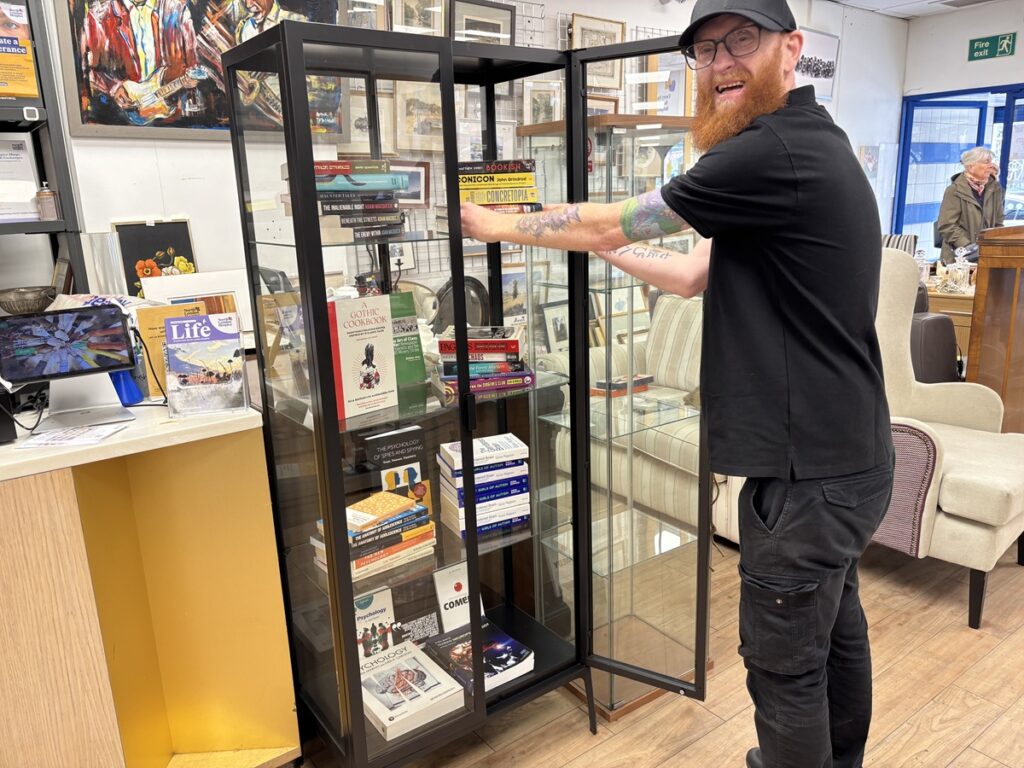 North London Hospice opening an enlarged book department with aftrnoon event featuring live cartooning, a caricuturist and raffle for signed copies of new books.