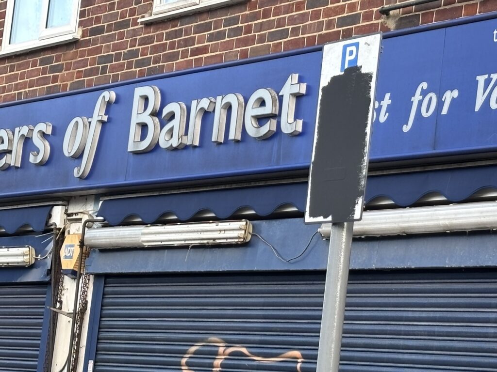 Blacked out parking charge signs in Mays Lane a sign of local anger over imposition by Barnet Council of pay-by-phone parking outside parade of shops.